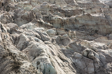 Aerial view of show and ice of Kashkatash Glacier on the west Caucasian mountains in Russia.