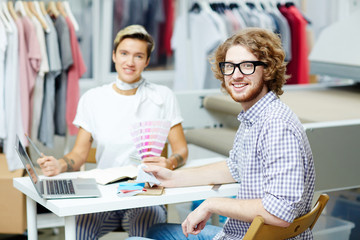 Group of designers sitting at the table and planning work together