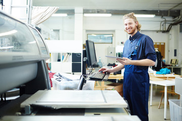 Portrait of man doing orders of his clients on printing machine