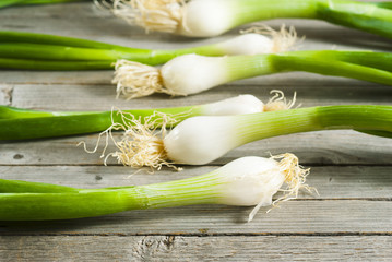 Spring onions on old wooden table