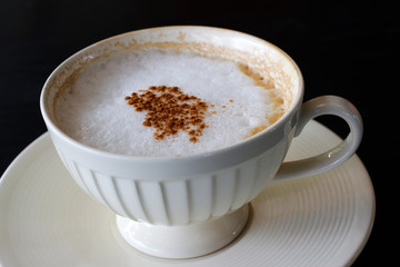 Hot Cappuccino  on black background 