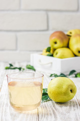 Pears in wooden box on light wooden background. Selective focus, space for text. 
