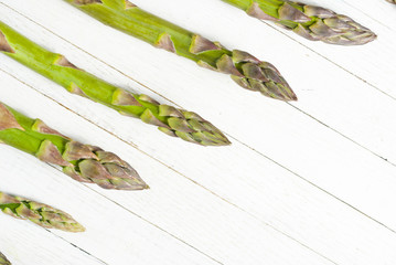 Green asparagus on white wood table