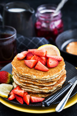 Stack of freshly prepared lemon poppy seed  pancakes with fresh strawberry