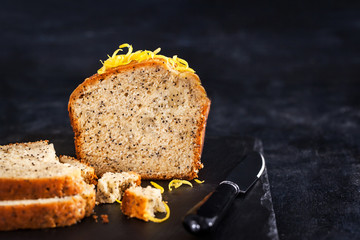 Lemon and poopy seeds pound cake on dark background