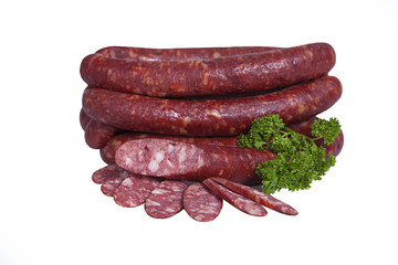 Fatty smoked sausage whole and partially sliced. Isolated on white background