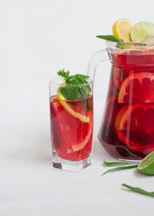 tasty and juicy sangria with citrus in a glass on a white background.