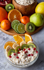 Breakfast still life with oatmeal porridge and fruits, top view, selective focus, shallow depth of field.