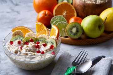 Breakfast still life with oatmeal porridge and fruits, top view, selective focus, shallow depth of field.