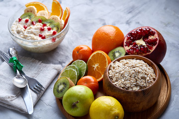 Breakfast still life with oatmeal porridge and fruits, top view, selective focus, shallow depth of field.