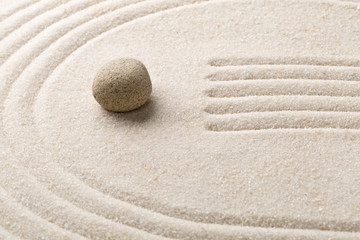 Zen sand and stone garden with raked lines and curves. Simplicity, concentration or calmness...