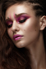 Brunette girl with a creative hairstyle braids, art make-up and the elf's ears. Beauty face. Photo taken in the studio.