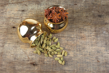 Star Anise Cardamom spice in golden metal pot