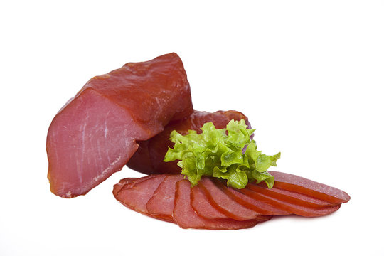 Beef balyk decorated with leaf of lettuce. Isolated on white background