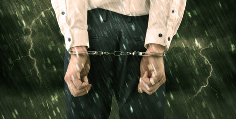 Stormy bad day concept with close handcuffed elegant man
