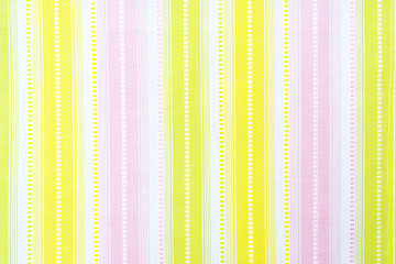 Pattern of multi-colored stripes on white cotton tablecloth or towel.
