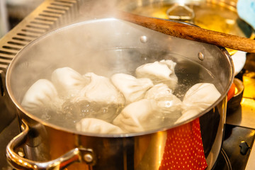 Traditional Georgian khinkali are cooked in a large saucepan.