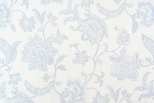 Blue ornate floral pattern on white cotton tablecloth.