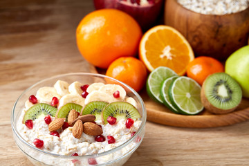 Breakfast still life with oatmeal porridge and fruits, top view, selective focus, shallow depth of field.