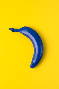 Blue banana on pink background