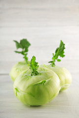 fresh green cabbage turnip on white wooden kitchen plate, can be used as background