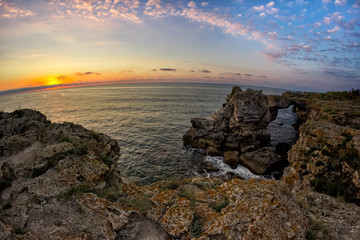 Fototapeta na wymiar Beautiful sunrise over the Black Sea with rocks on the shore, Tyulenovo, Bulgaria