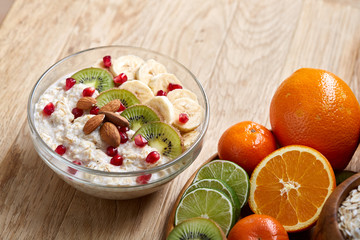 Breakfast still life with oatmeal porridge and fruits, top view, selective focus, shallow depth of field.