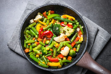 Stir fry vegetables in the wok.