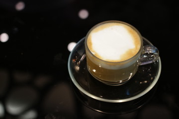 Hot Cappuccino on black background 