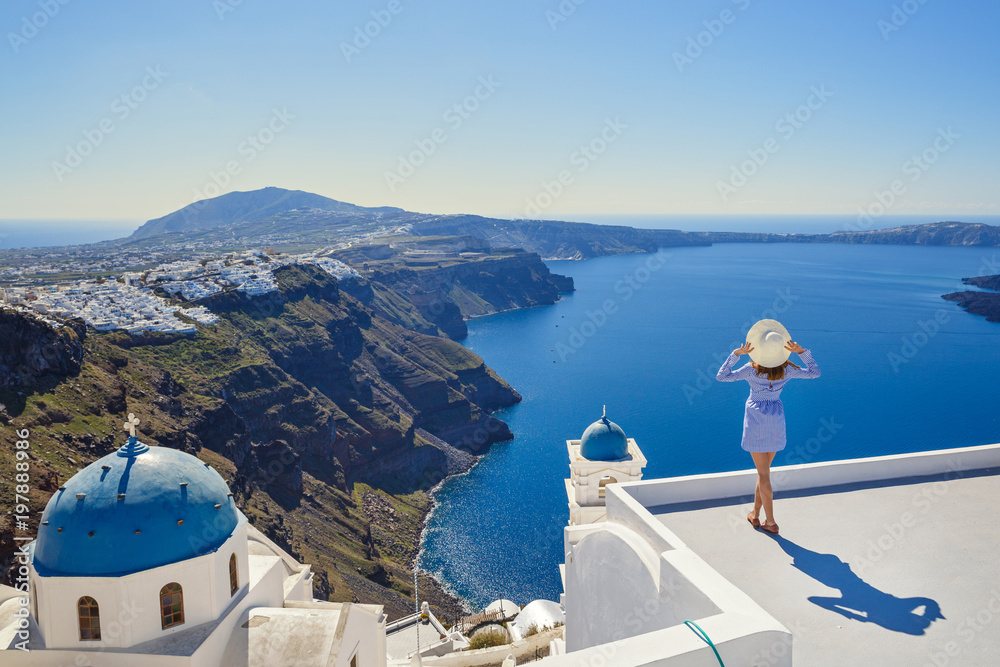 Wall mural young woman looks at the marine landscape