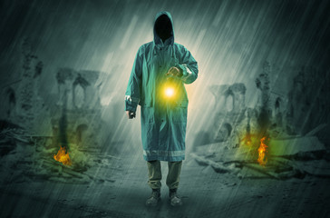 Destroyed place after a catastrophe with man in raincoat and lantern concept