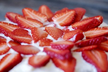 Delicious cake with fresh strawberries and cream  