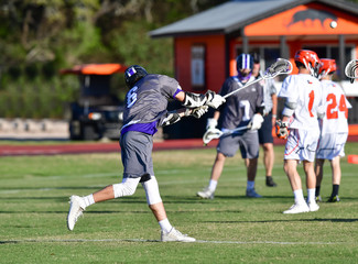 Lacrosse player attempting a goal during a match © Joe