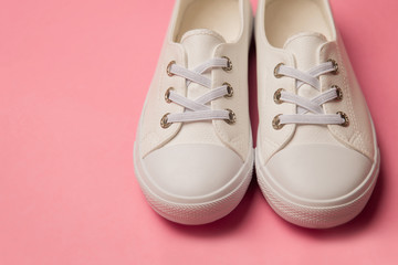 Overhead Shot Of White female Sneakers On Pastel Pink Background