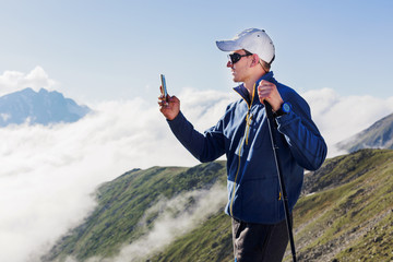 Man tourist takes pictures on mobile phone.