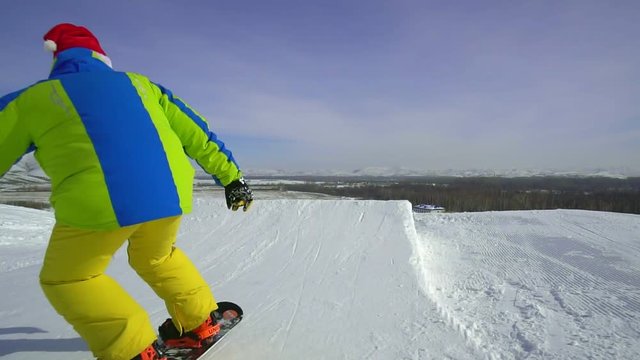 man skiing snowboarder makes a jump freeride in the ski resort