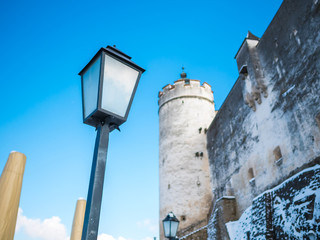 Fototapeta na wymiar lamp light fortress castle blue sky salzburg austria winter snow