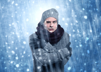 Handsome young boy shivering and trembling at snowstorm concept
