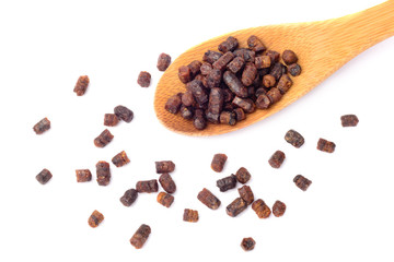 Granules of bee bread in a wooden spoon are isolated on a white background. Apitherapy. Beekeeping products. Strengthening immunity.