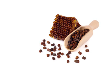 Bee bread granules and a piece of honey cells are isolated on a white background. Natural remedy...