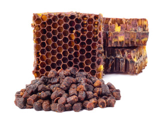 Bee bread granules and a piece of honey cells are isolated on a white background. Natural remedy...