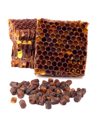 Bee bread granules and a piece of honey cells are isolated on a white background. Natural remedy...