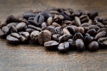 Coffee grains, close-up on a textural background in the form of a tree.