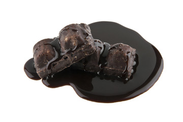 chocolate candy in liquid chocolate isolated on white background