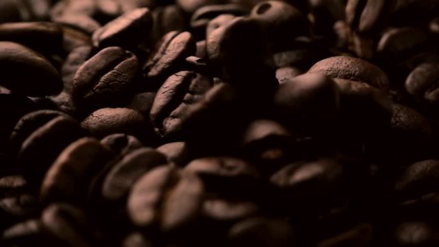 Roasted coffee beans falling in slow motion