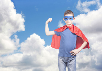 Superhero kid showing his strength. Success and confidence concept