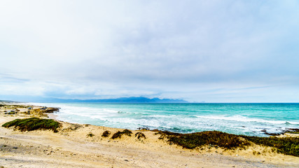 The beautiful beaches on False Bay along Baden Powell Drive between Macassar and Muizenberg near Cape Town, South Africa