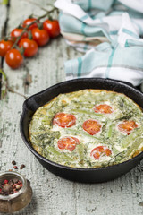 classic omelet with cherry tomatoes, cheese and herbs