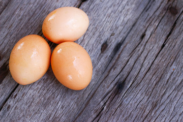 Three eggs on wooden background 