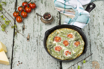 classic omelet with cherry tomatoes, cheese and herbs